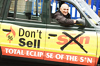 Pic: Taxi with don't buy the Sun outisde